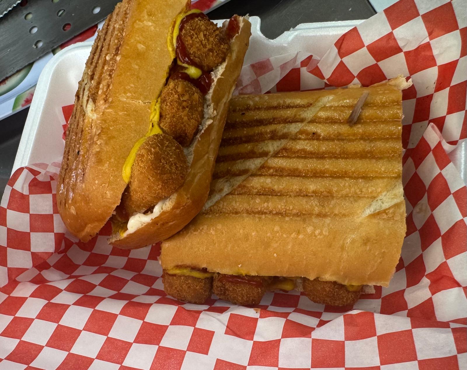 Croqueta sandwich with mustard and ketchup, pressed