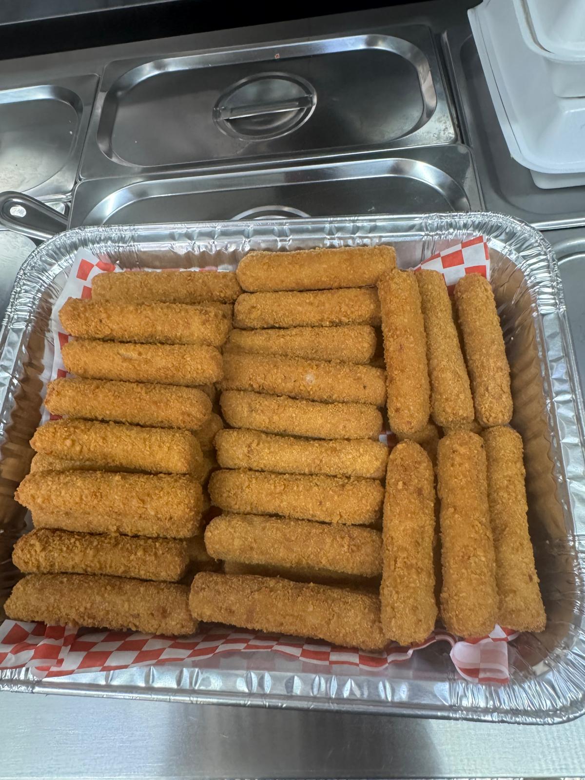 Tray of golden Cuban croquetas fresh from the fryer