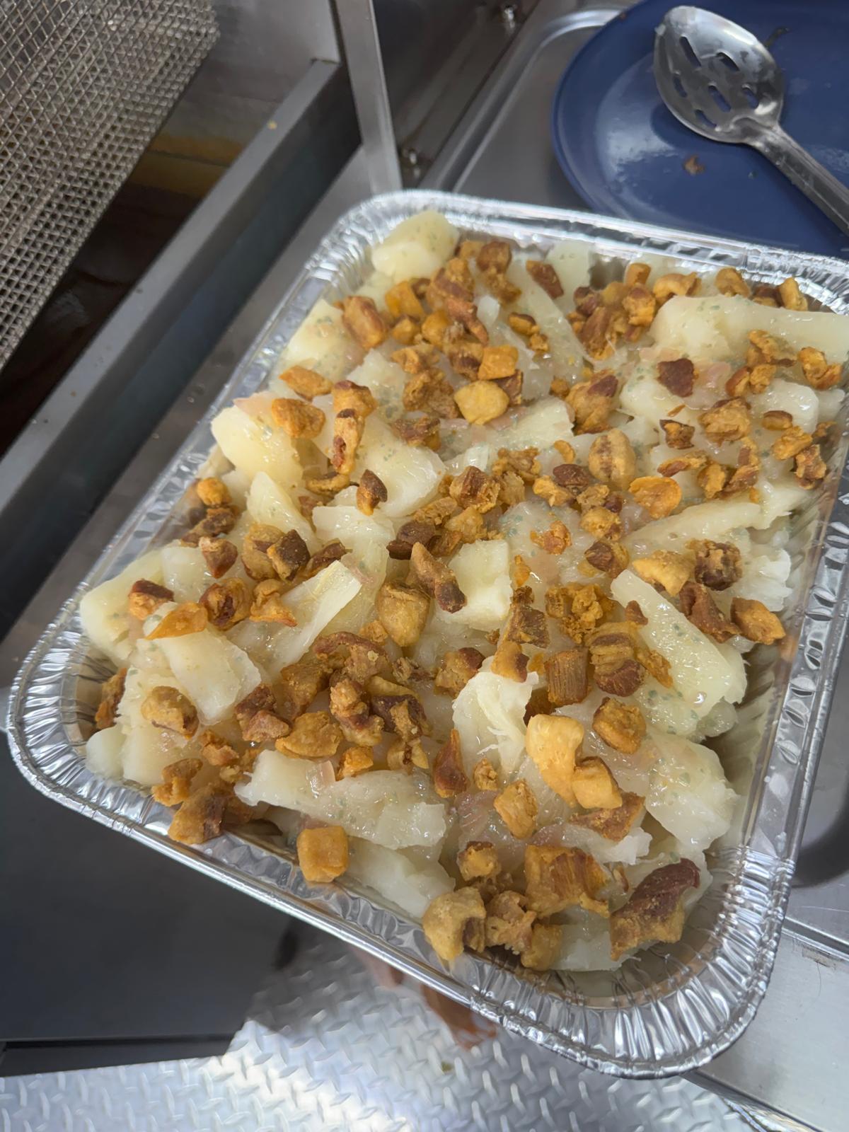 Yuca con mojo topped with crispy pork chicharrón