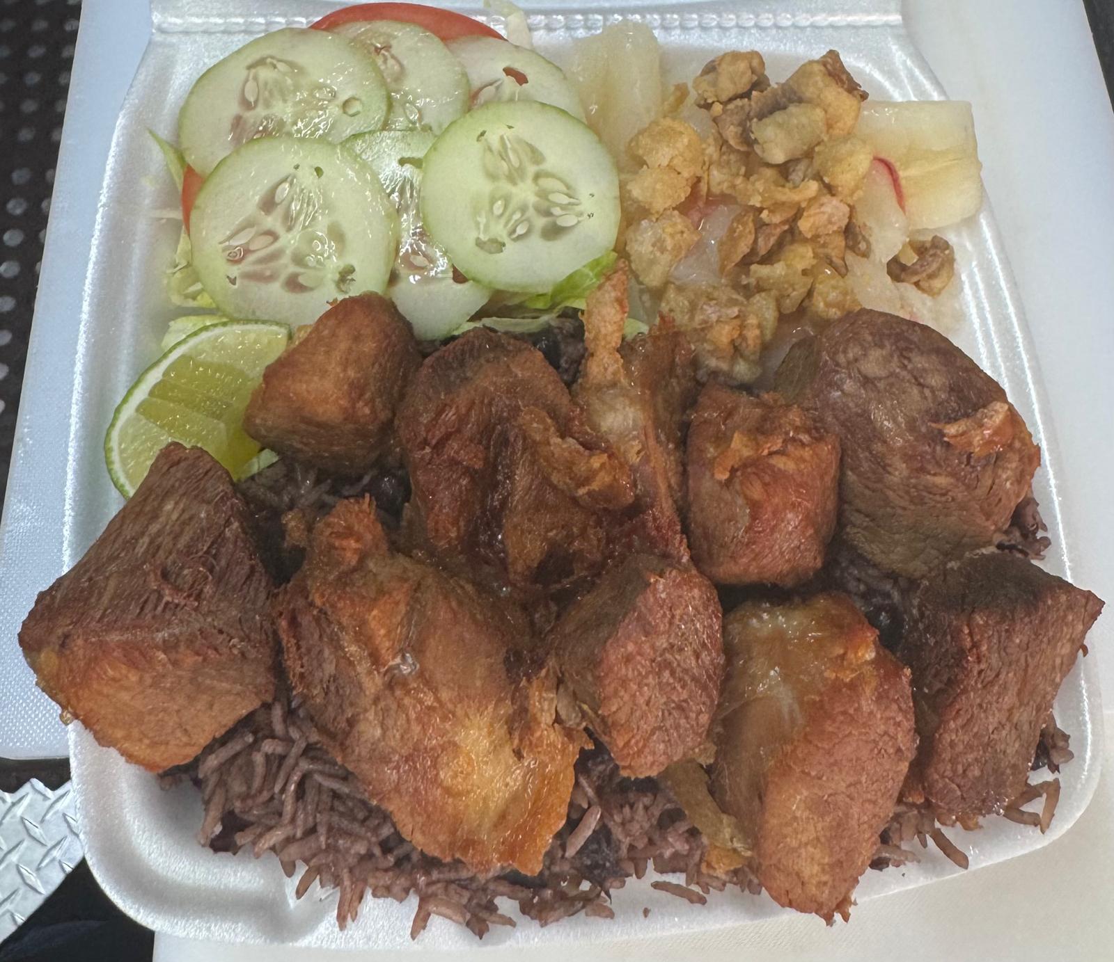 Completa de masa de cerdo — fried pork plate with rice, yuca and salad